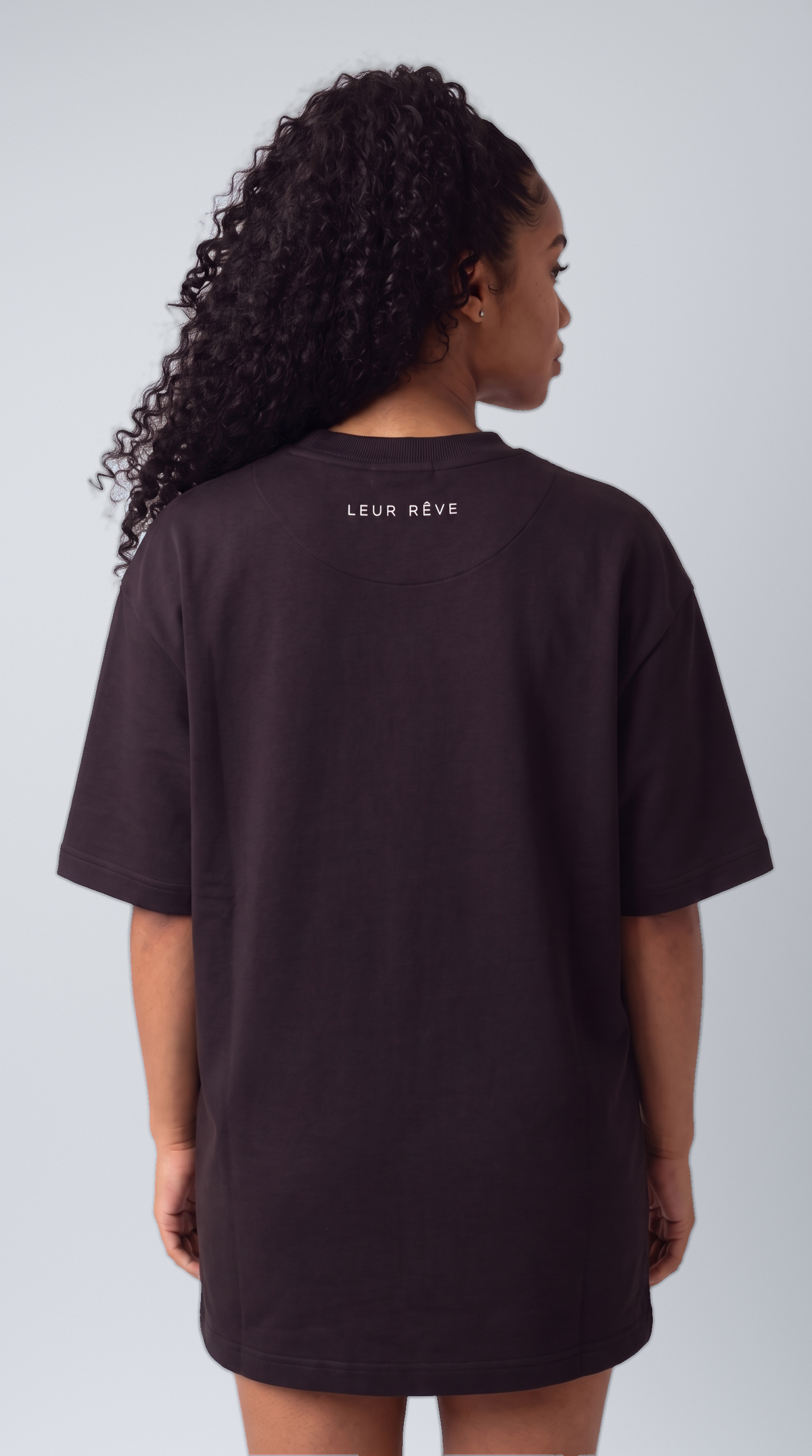 Woman wearing the Leur Rêve Tee in black, back view