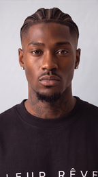 Close-up of a man wearing the Leur Rêve Tee in black