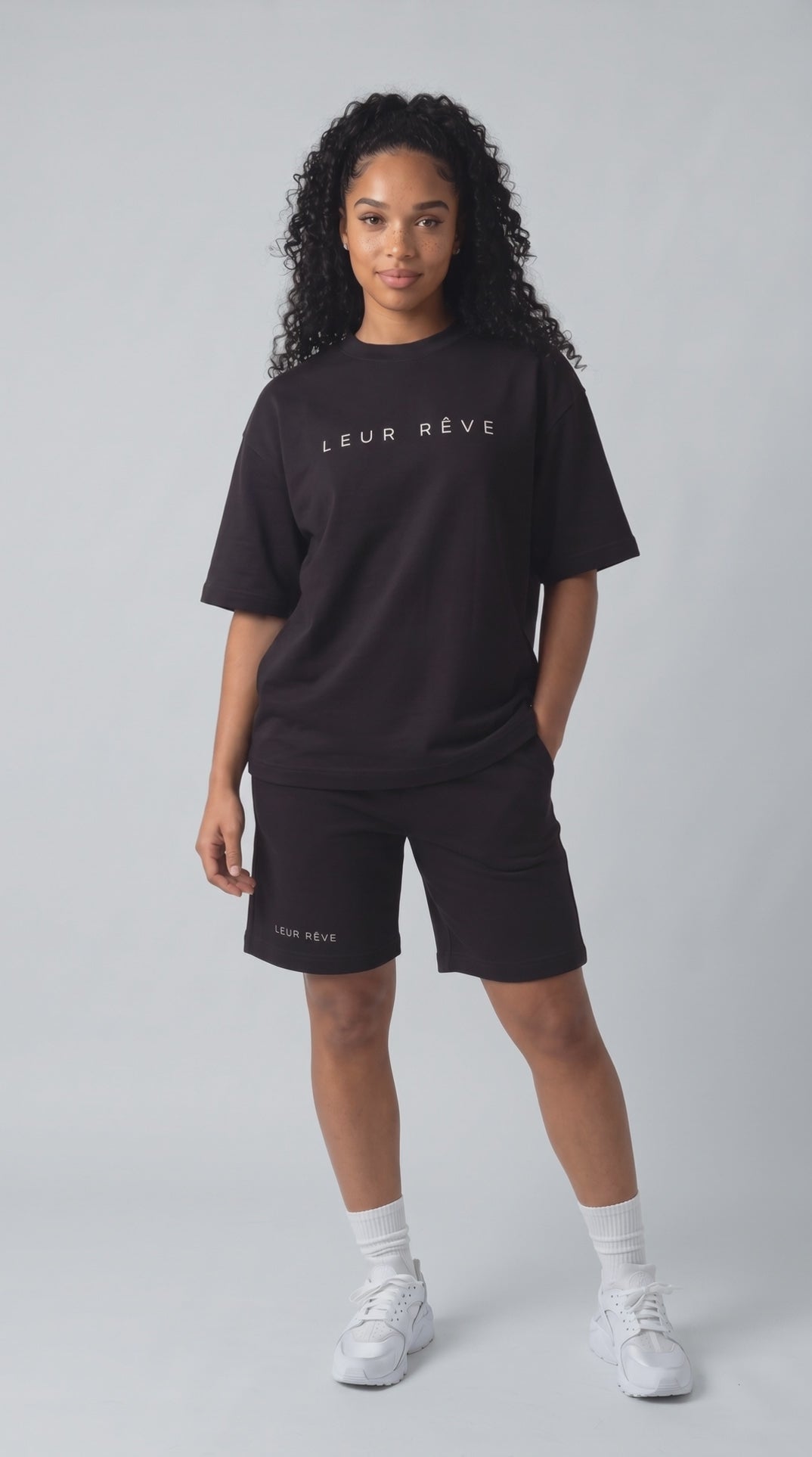 Blue in the Leur Rêve black tee and short, moving in the studio