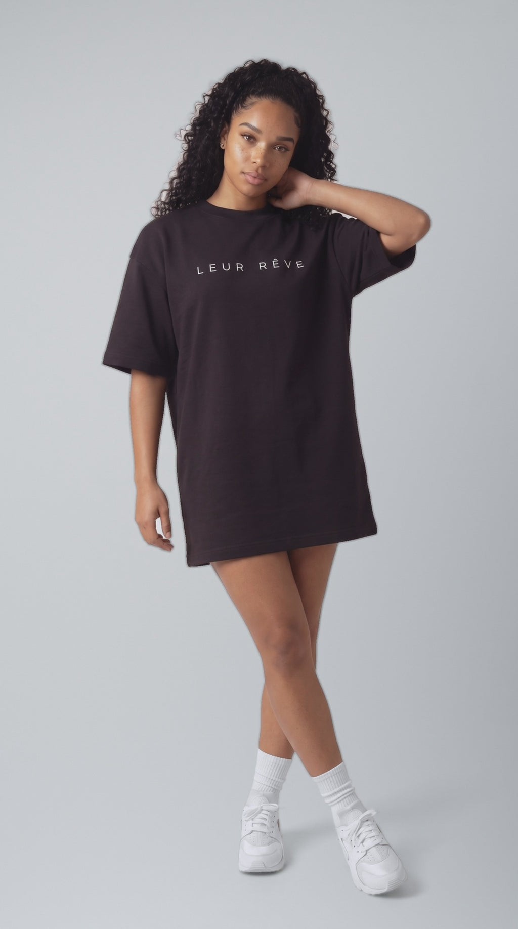 Blue in the Leur Rêve black tee, moving in the studio