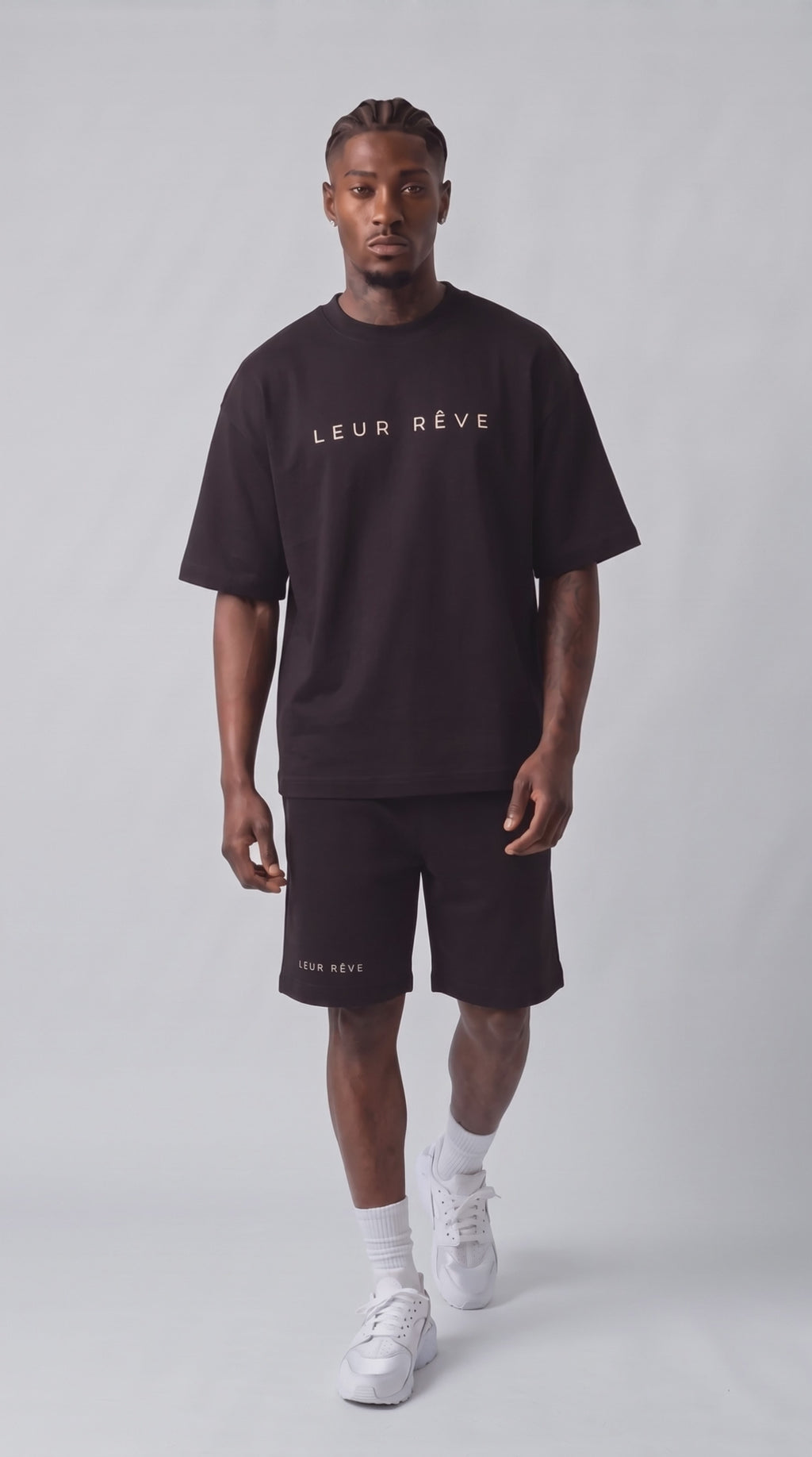 Prince walking in the Leur Rêve black tee and short
